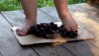 MILF tramples grapes with her unprotected feet.