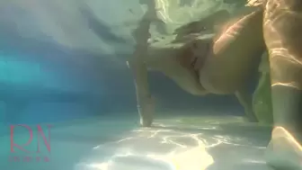 Elegant and flexible babe, swimming underwater in the outdoor swimming pool. three one