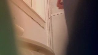 Sexy young blonde bathroom spy