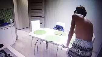 Woman walking around home topless